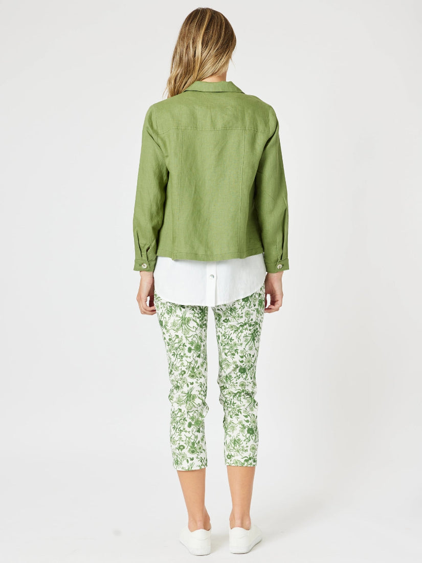 Person wearing a green jacket and floral pants on a white background