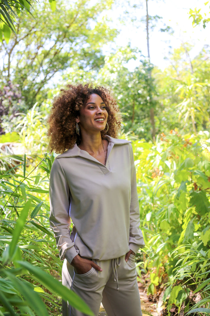 Woman standing in a lush green garden