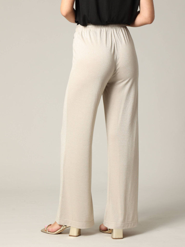 Beige wide-leg pants worn by a person on a plain background