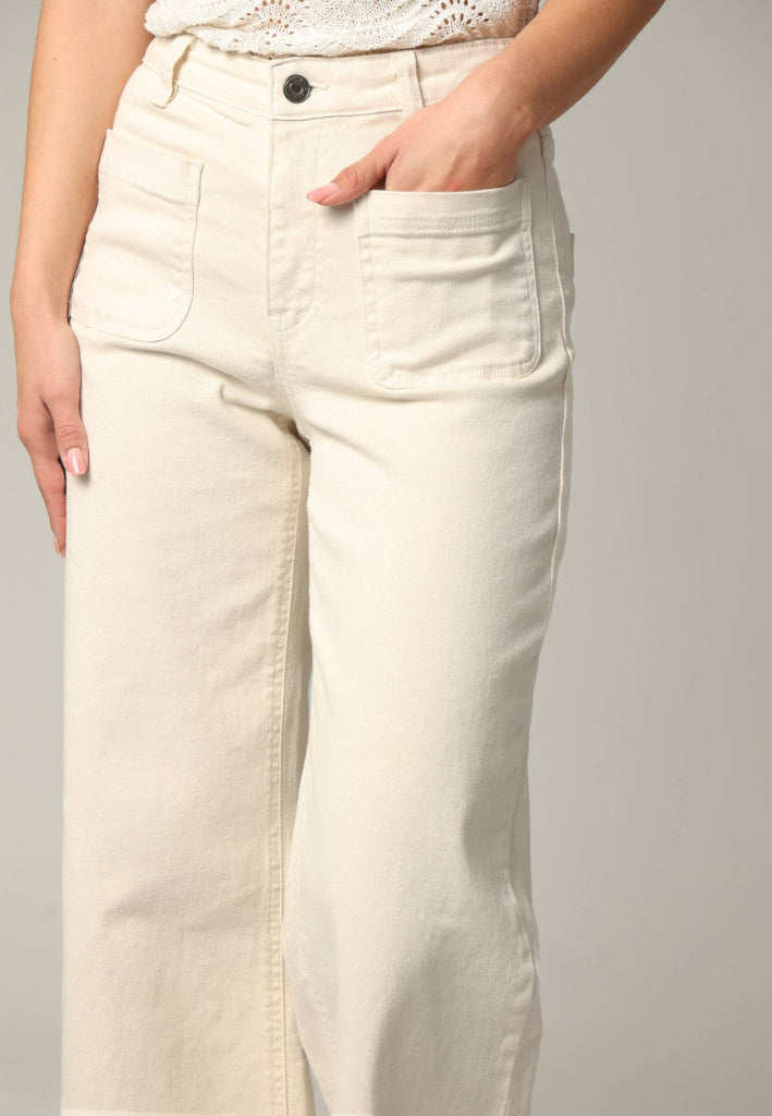Beige pants worn by a person on a plain background