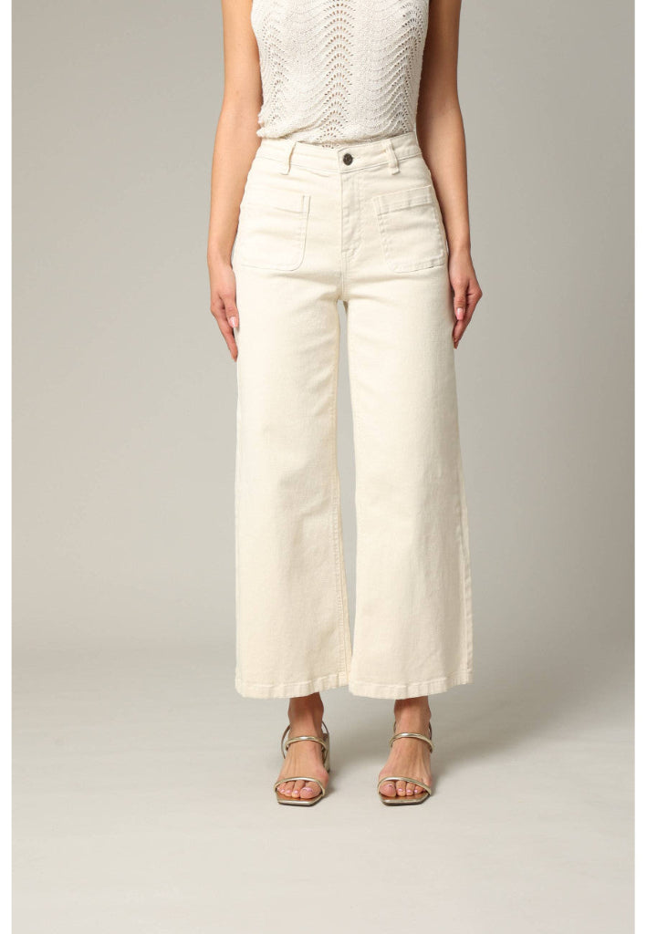 Person wearing white wide-leg pants on a plain background