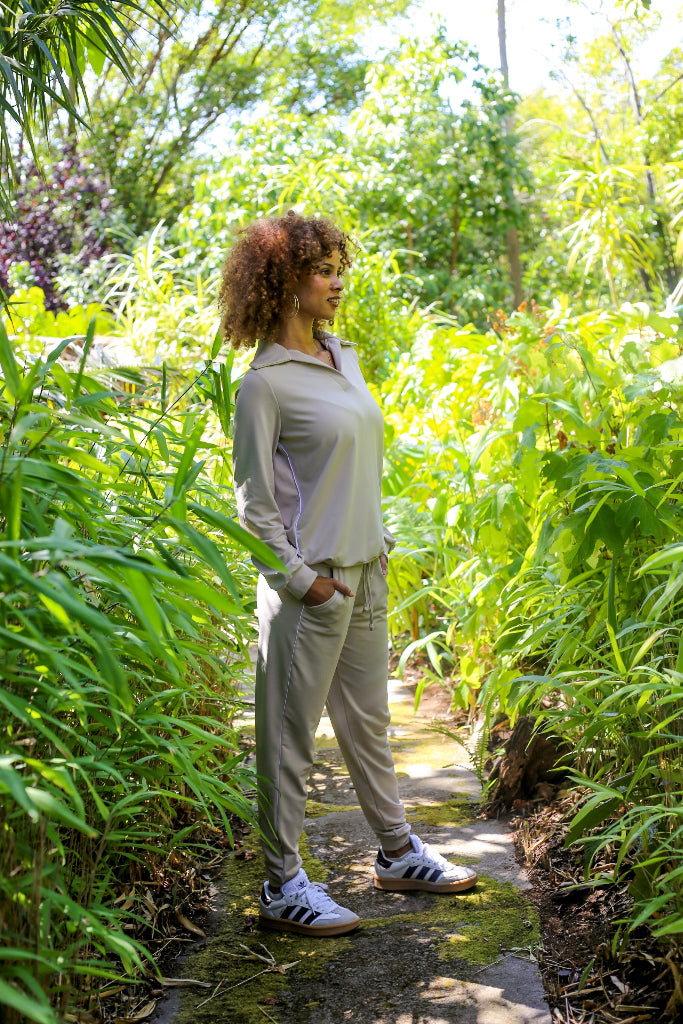 Woman standing in a garden surrounded by greenery