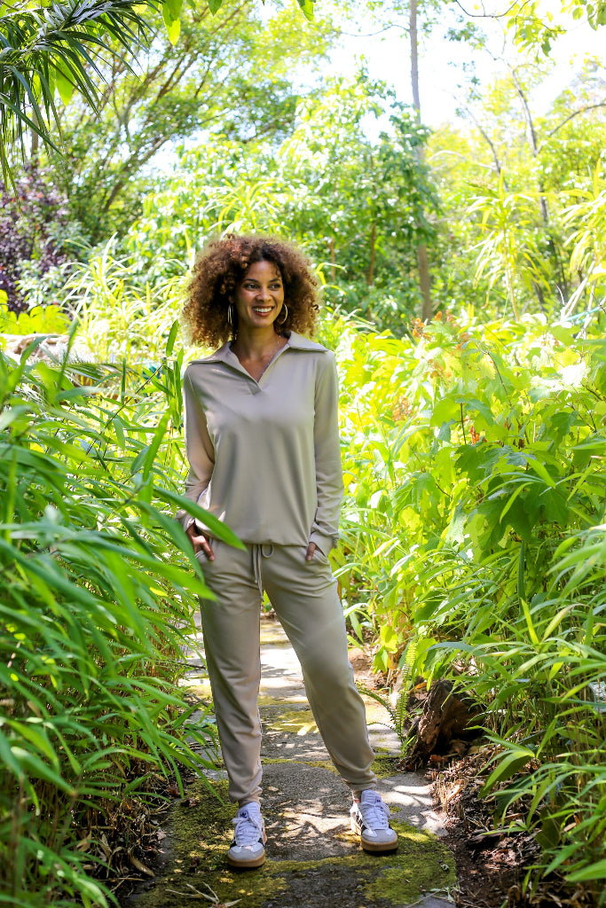 Woman standing in a lush green garden