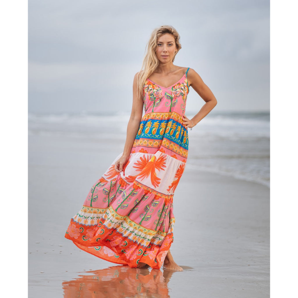 Woman wearing a colorful dress on a beach