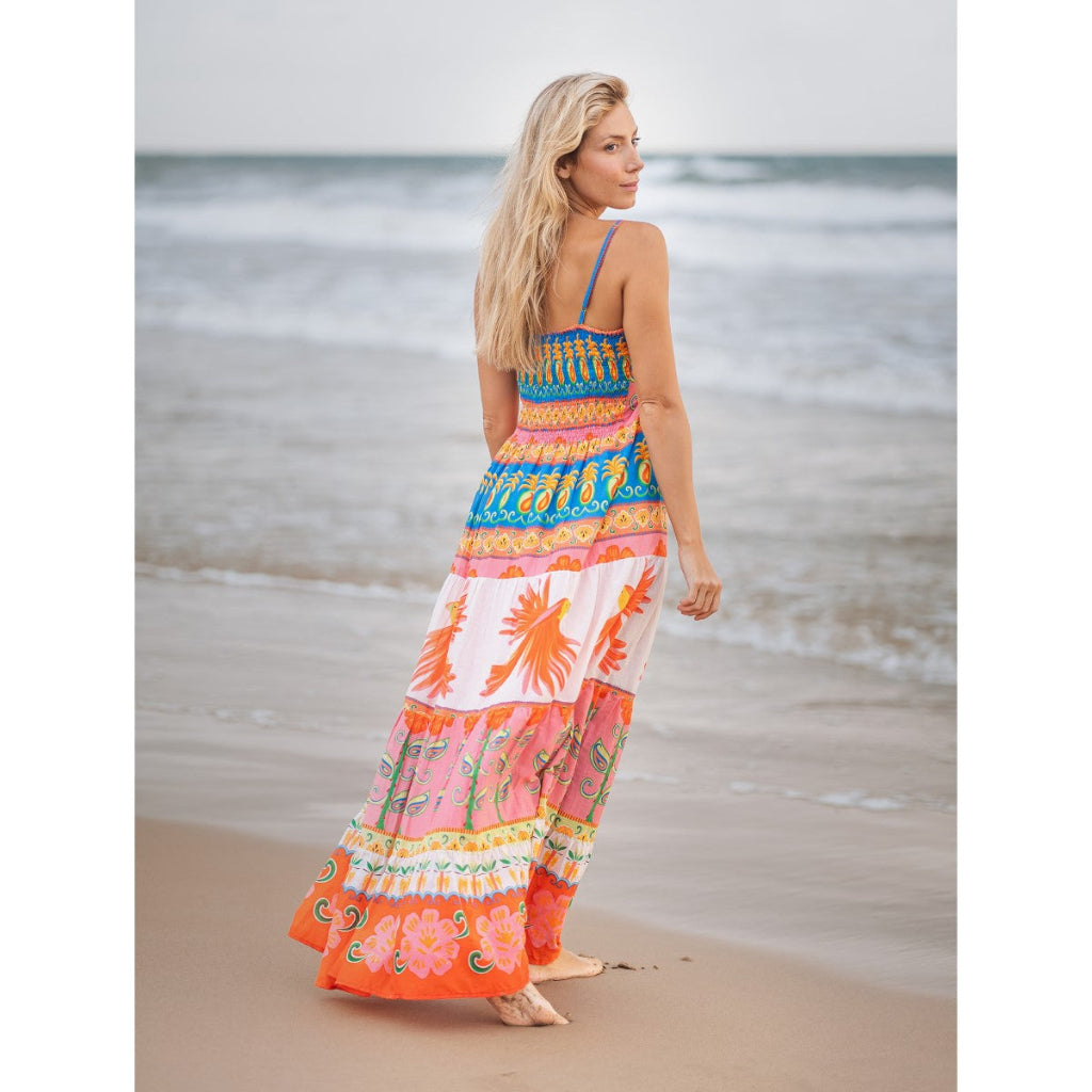 Woman in a colorful dress walking on a beach