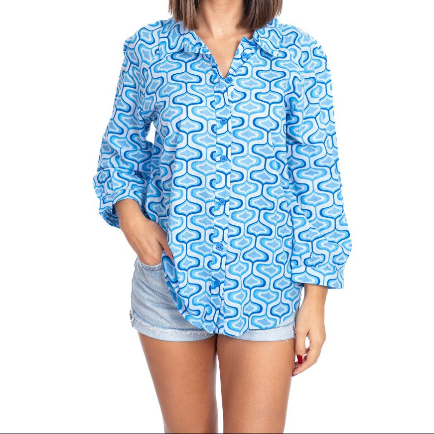 Woman wearing a blue patterned shirt on a white background