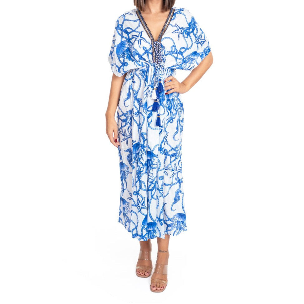 Woman wearing a blue and white floral dress on a white background