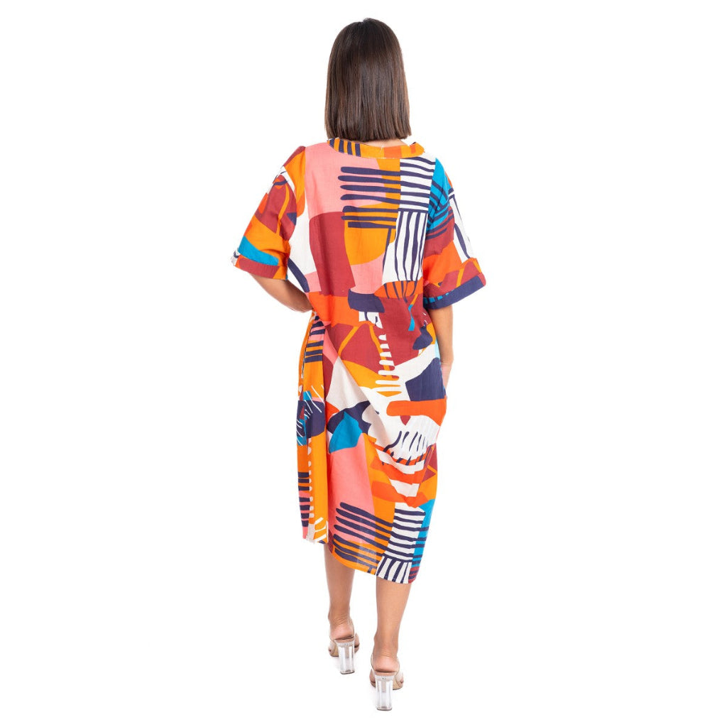 Woman wearing a colorful patterned dress on a white background