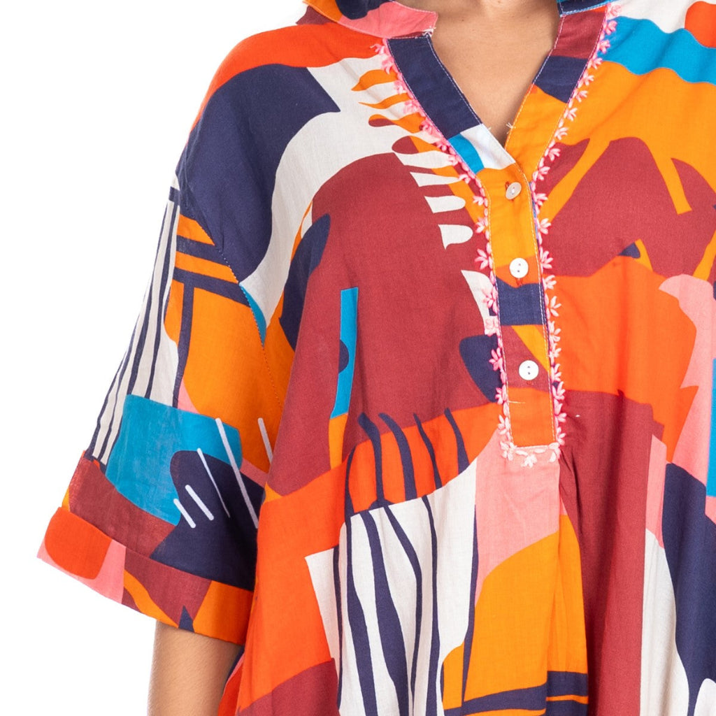 Colorful patterned dress with abstract designs on a white background