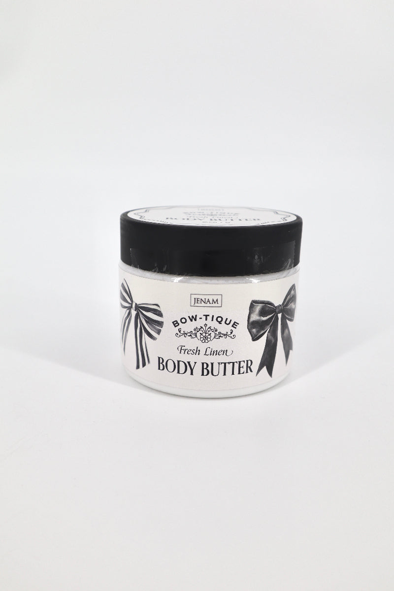 Jar of body butter with black lid and white label on a light gray background