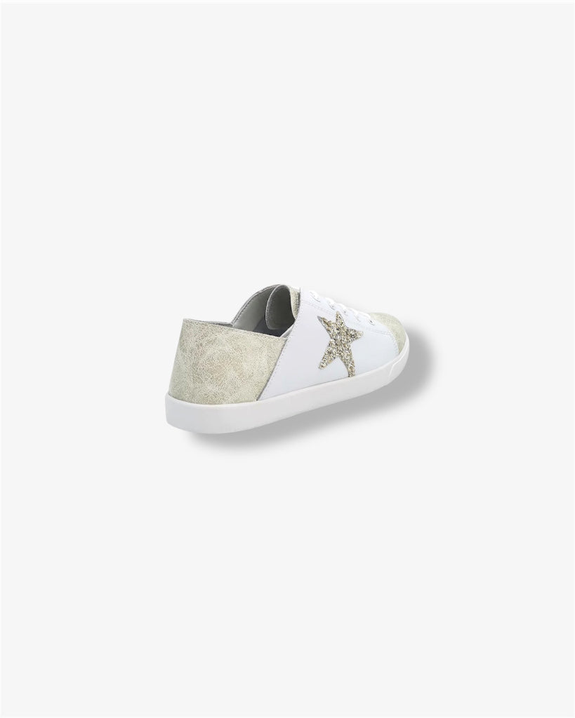 side view champagne gold and cream colored leather lace up sneaker