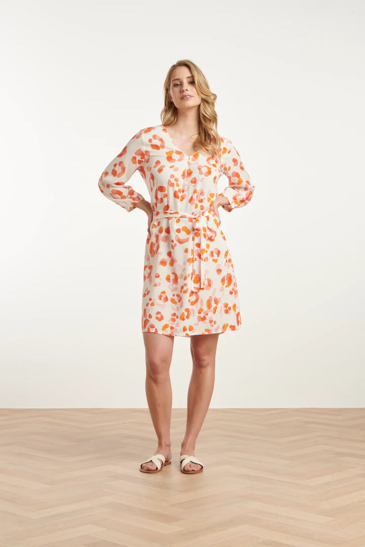 Woman wearing a Smashed Lemon leopard print dress on a white background