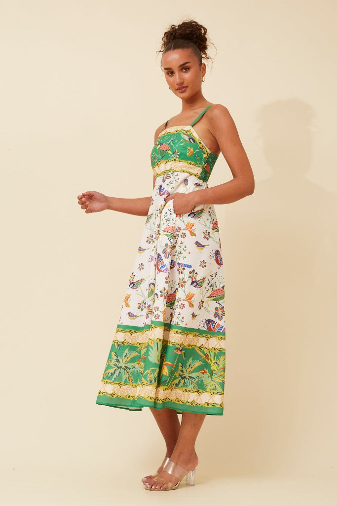 Woman wearing a Stella Morgan D733248 Dress colorful dress with a pattern on a beige background