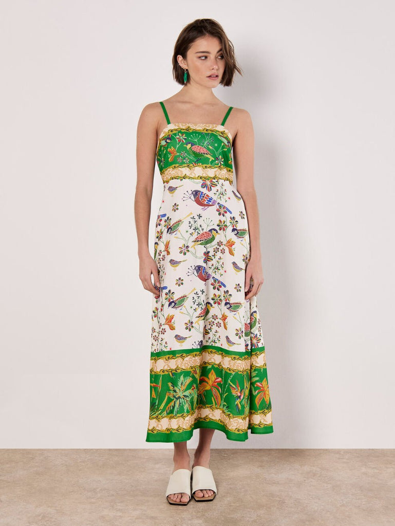 Woman wearing a Stella Morgan D733248 Dress floral and green dress with a plain background