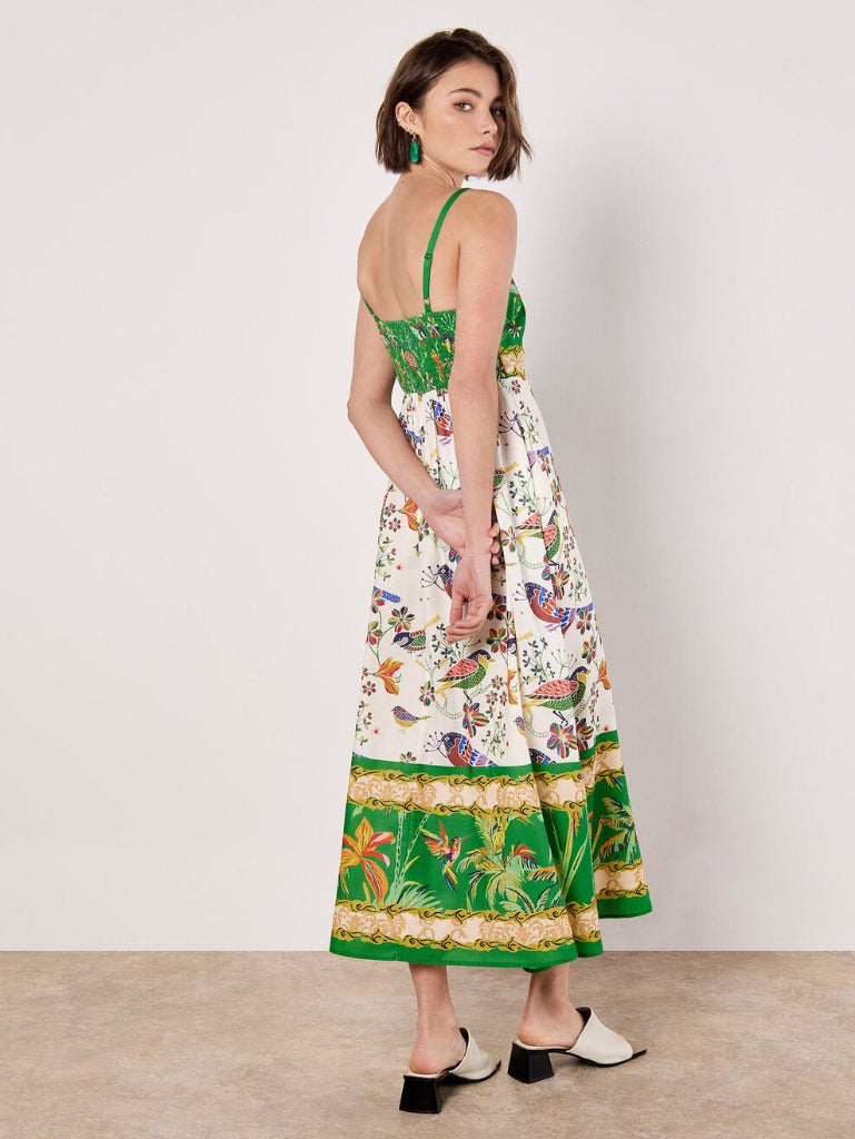 Woman wearing a Stella Morgan D733248 Dress floral and green dress with a white background