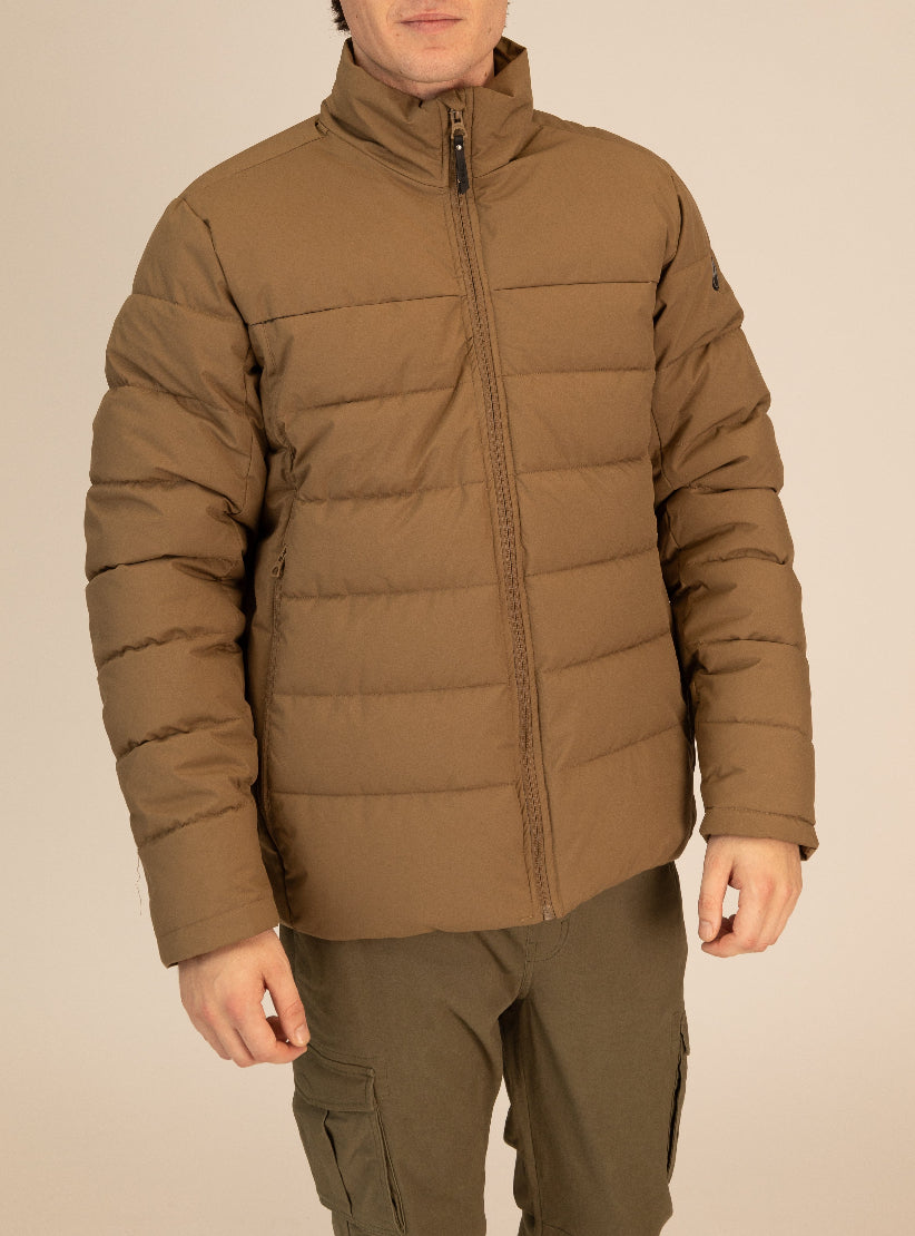 Person wearing a brown puffer jacket on a beige background