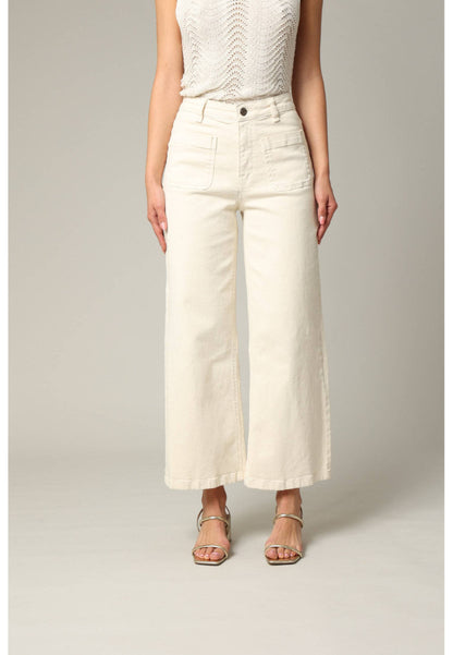 Person wearing white wide-leg pants on a plain background