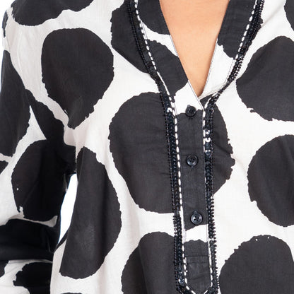 Close-up of a black and white patterned garment with buttons.