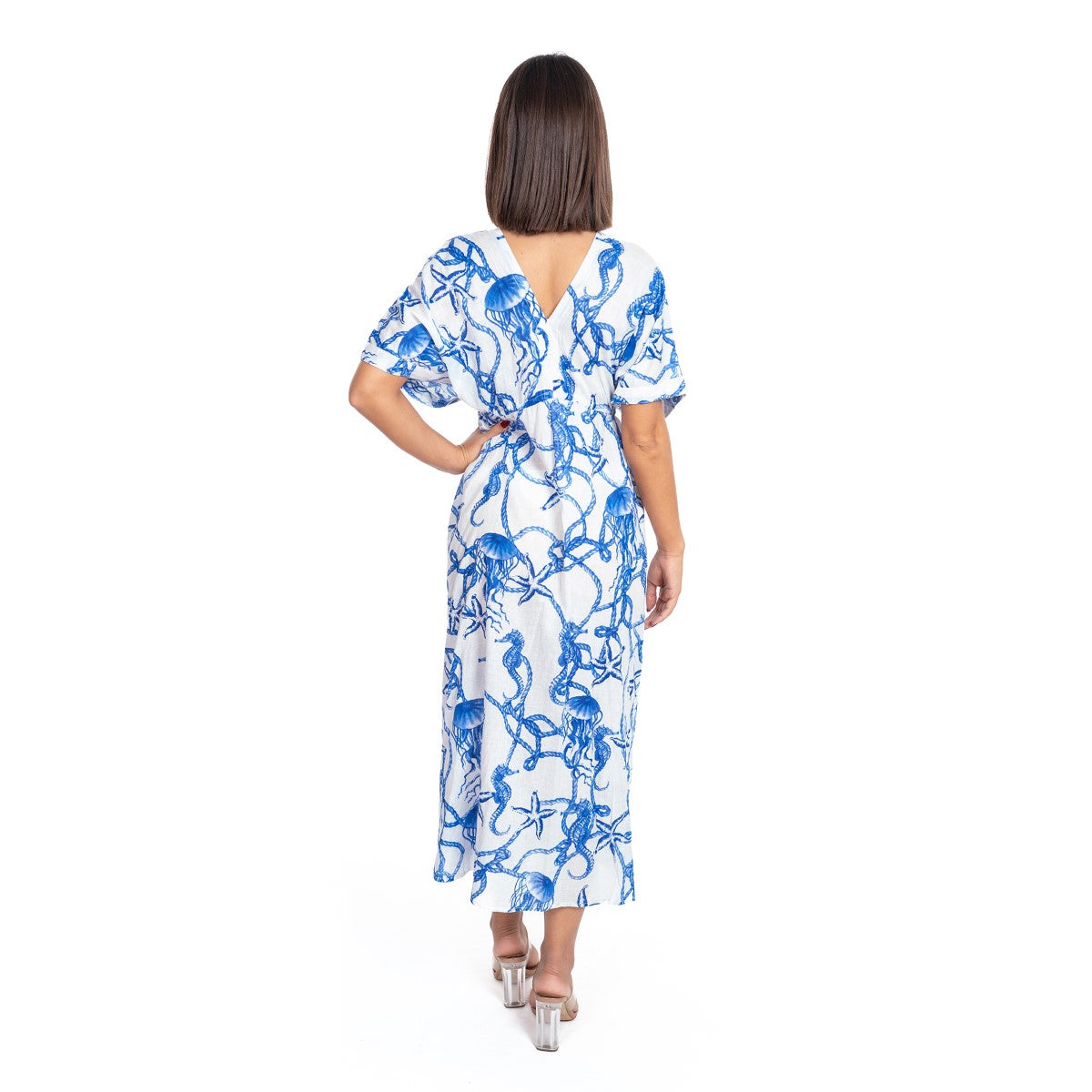 Woman wearing a blue and white floral dress on a white background