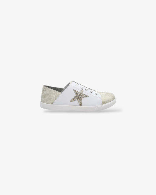 side view champagne gold and cream colored leather lace up sneaker