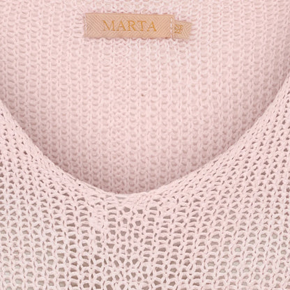 Close-up of a textured pink fabric with 'Marta' branding.