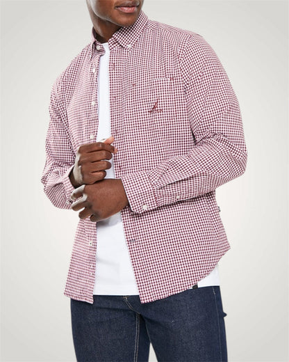 Person wearing a red and white checkered shirt over a white shirt with rolled-up sleeves.