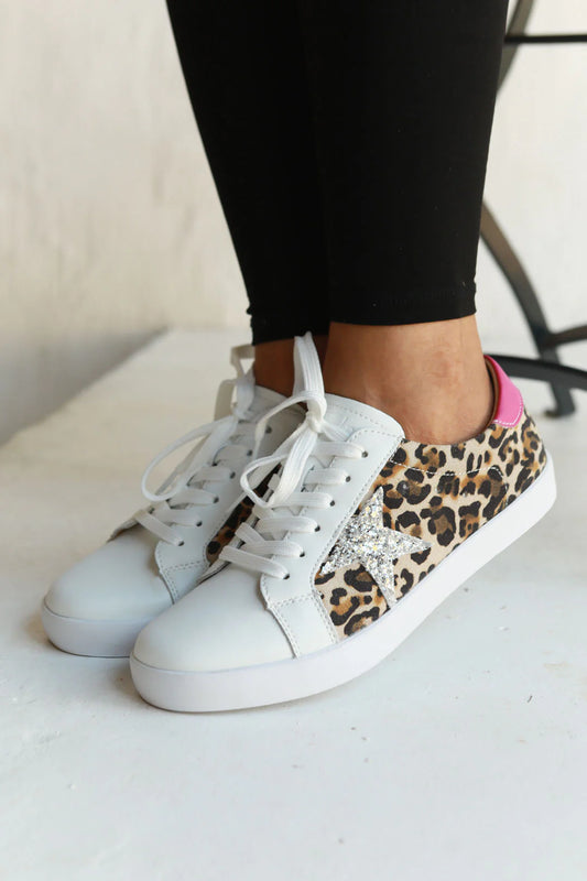 view of shoe on model. leathe sneaker with leopard print and glitter star